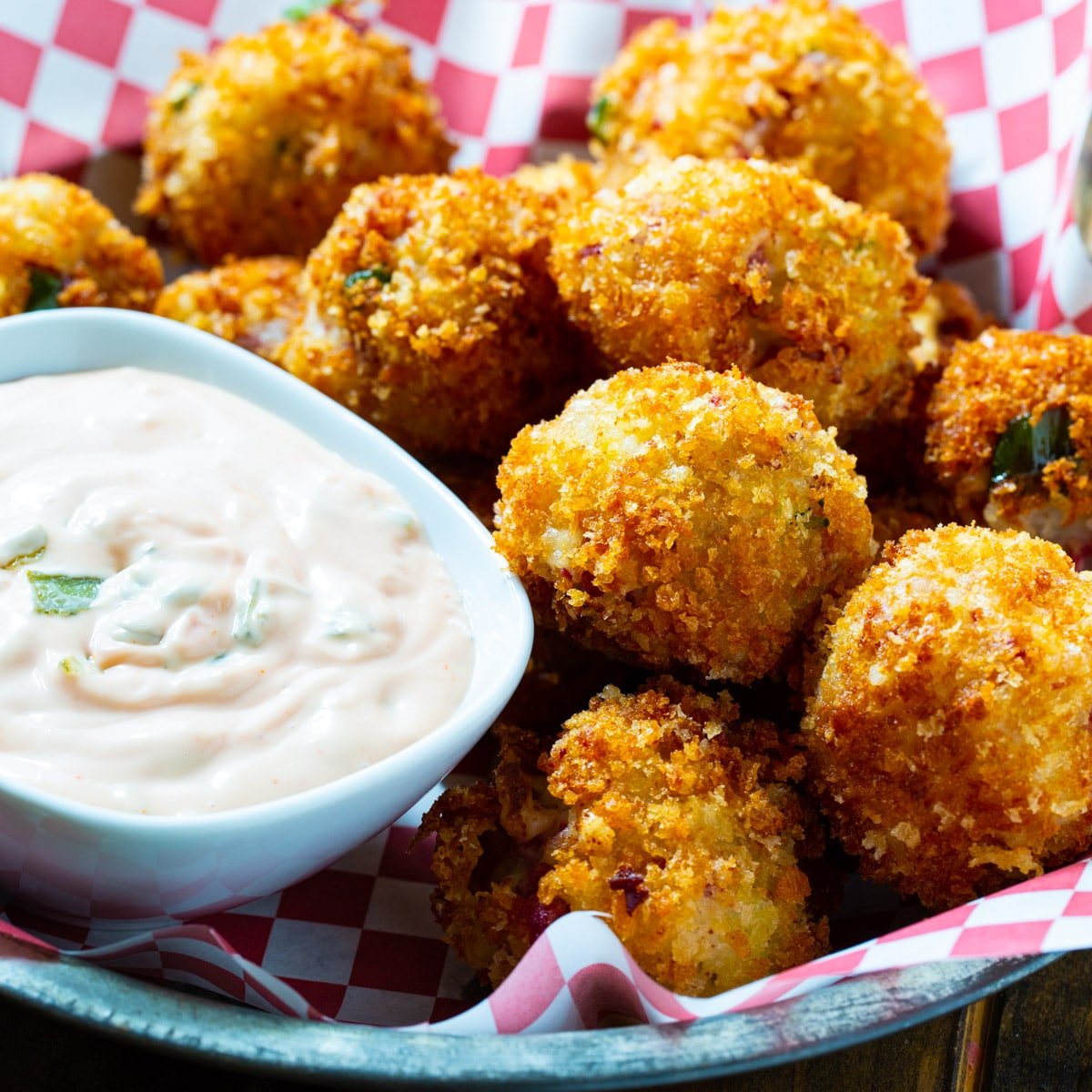 Reuben Fritters in a basket with Thousand Island dressing.