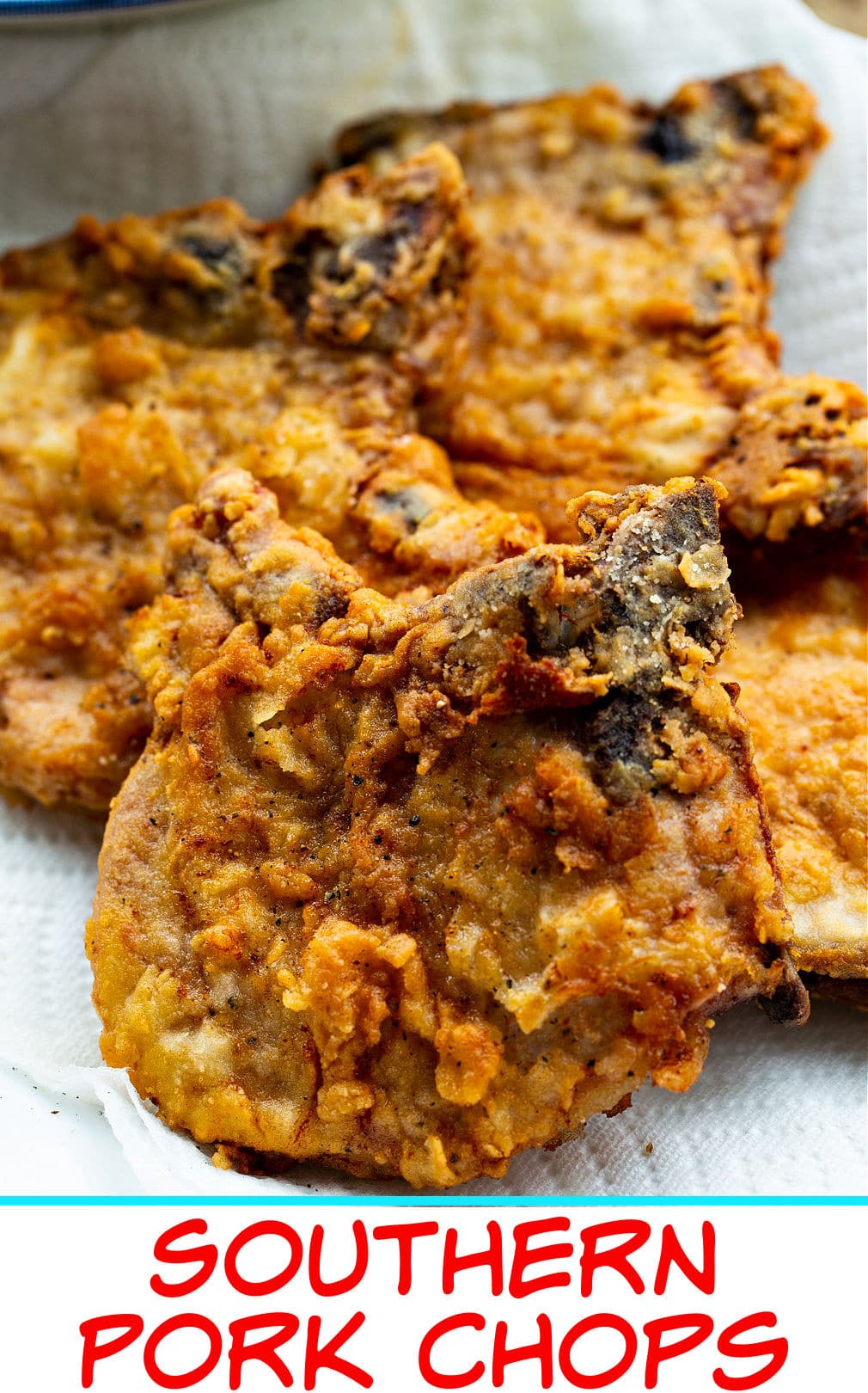 Southern Fried Pork Chops on paper towel-lined plate.