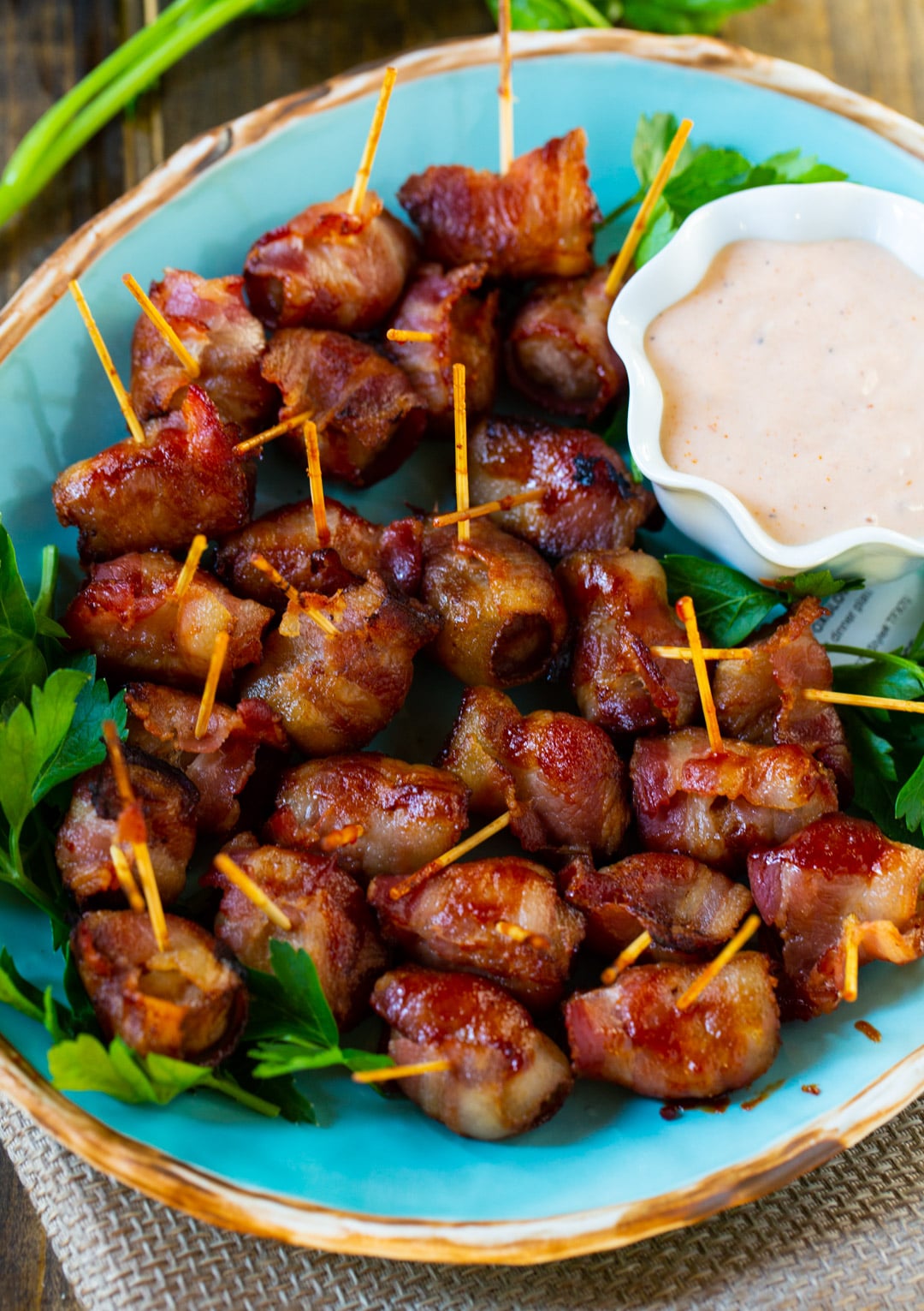 Bacon-Wrapped Water Chestnuts on serving platter with dip.