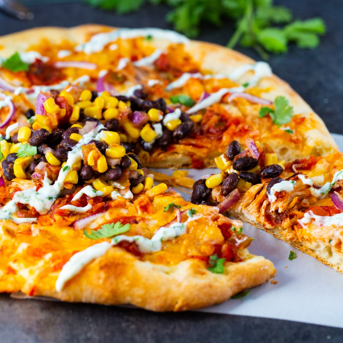 Chipotle Chicken Pizza with a slice cut.