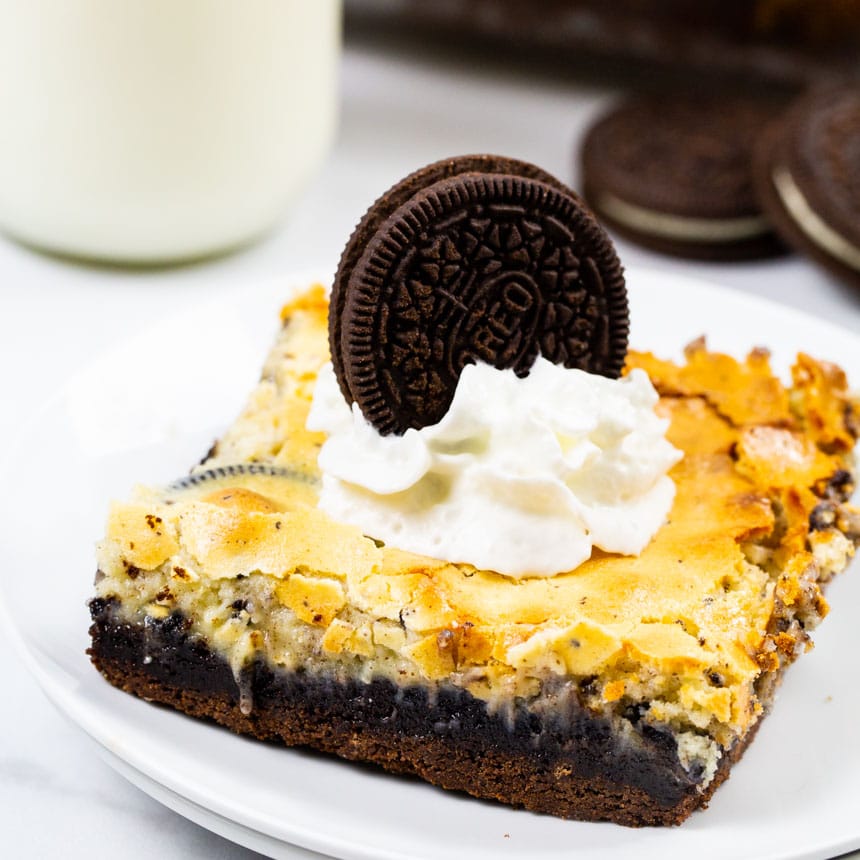 Cookies and Cream Gooey Bars topped with whipped cream.