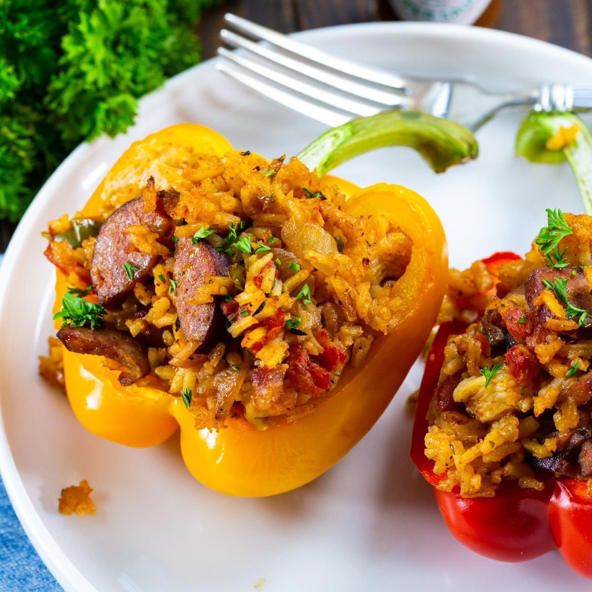 Two Jambalaya Stuffed Peppers on a plate.