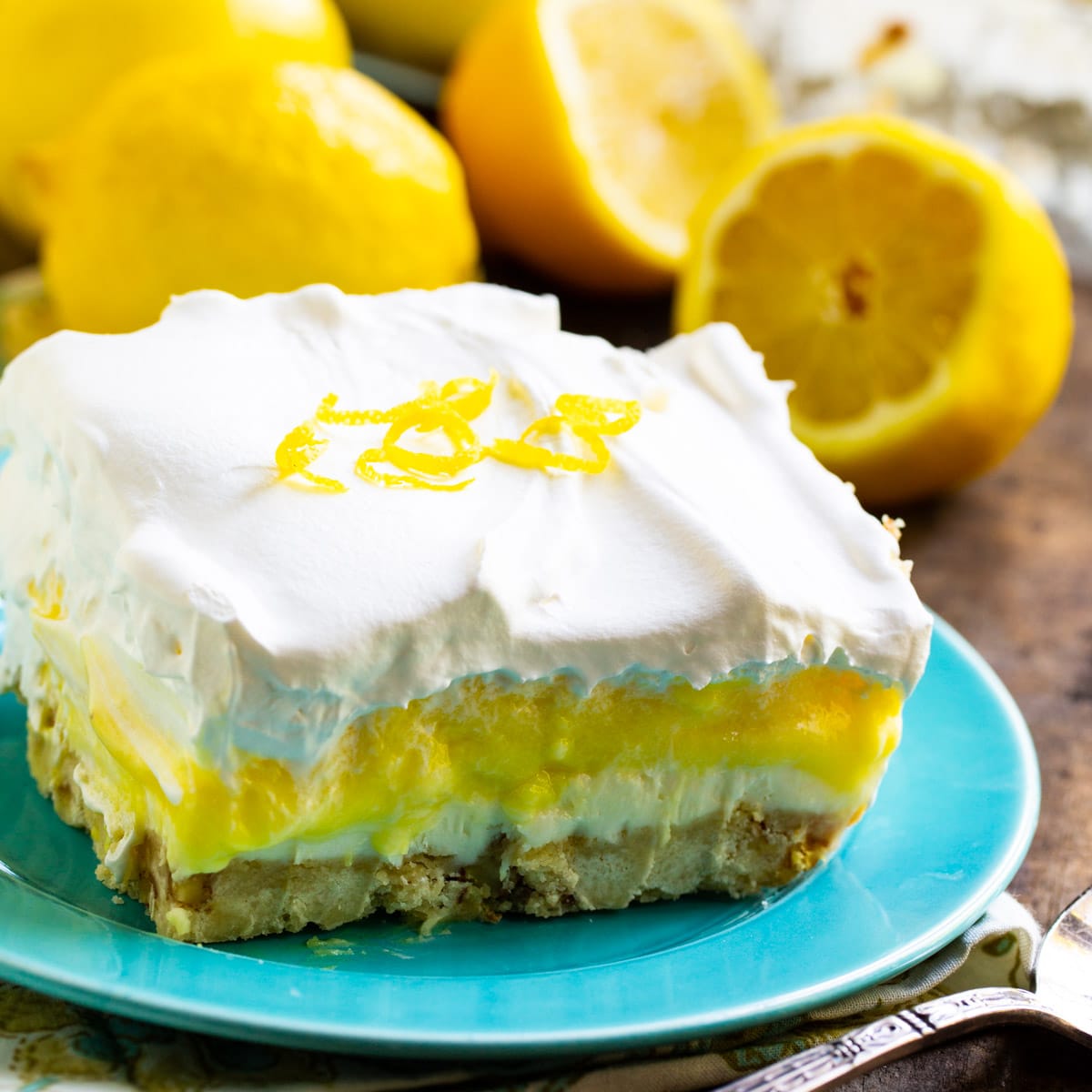 Slice of Lemon Lush on a blue plate.