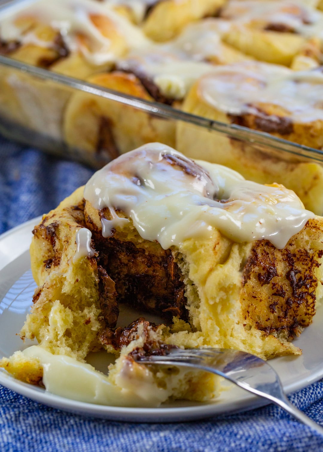 Fork cutting into Nutella Cinnamon Roll.