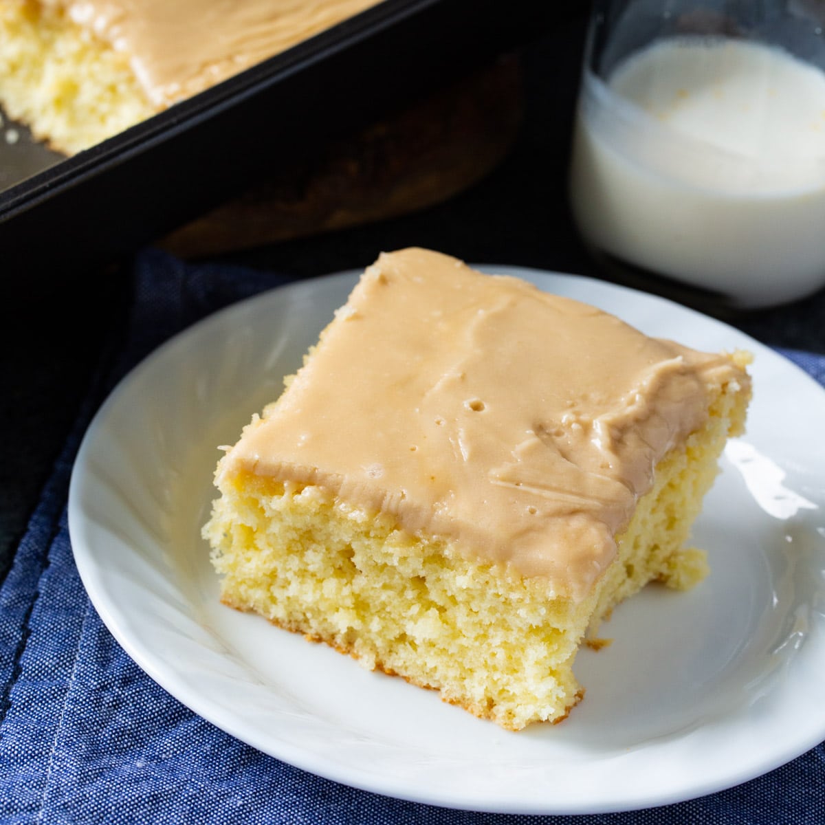 Slice of Buttermilk Sheet Cake with Caramel Icing on small plate.