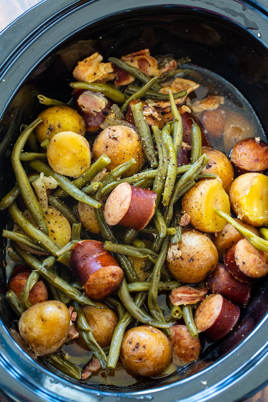 Slow Cooker full of potatoes, sausage, and green beans.