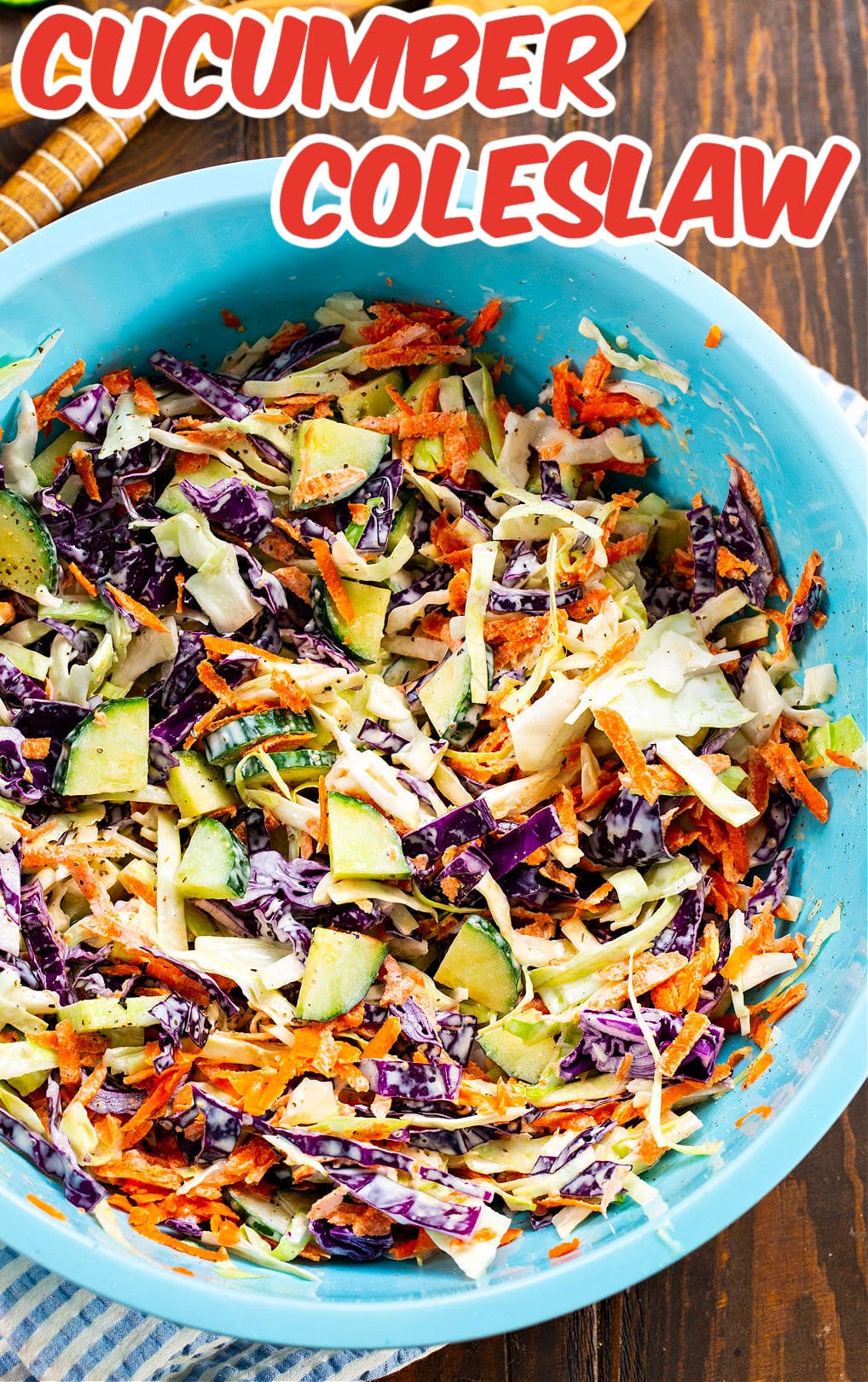 Coleslaw with cucumbers in large blue bowl.