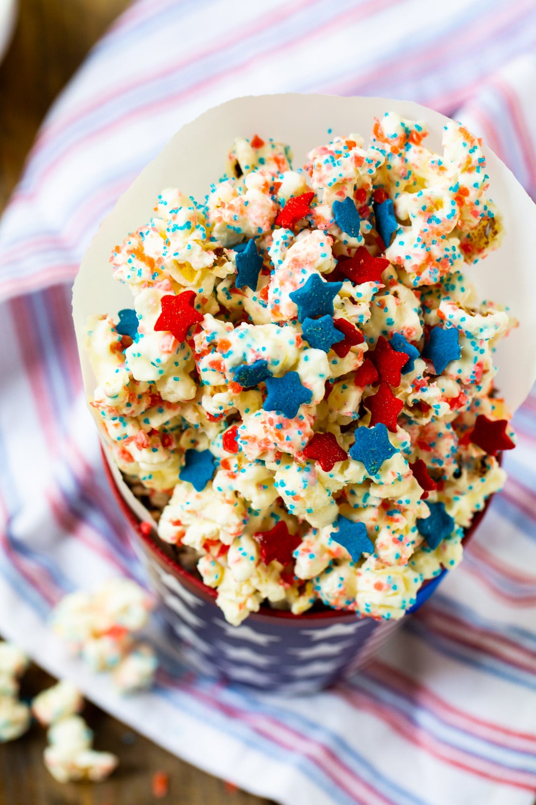 Firecracker Popcorn in a red, white, and blue paper cup.