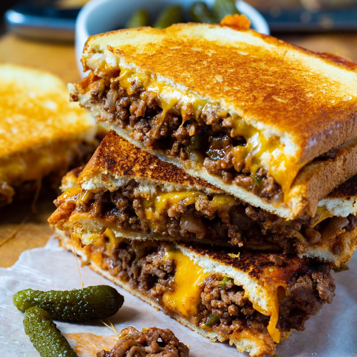 Sloppy Joe Grilled Cheese halves stacked on top of each other.