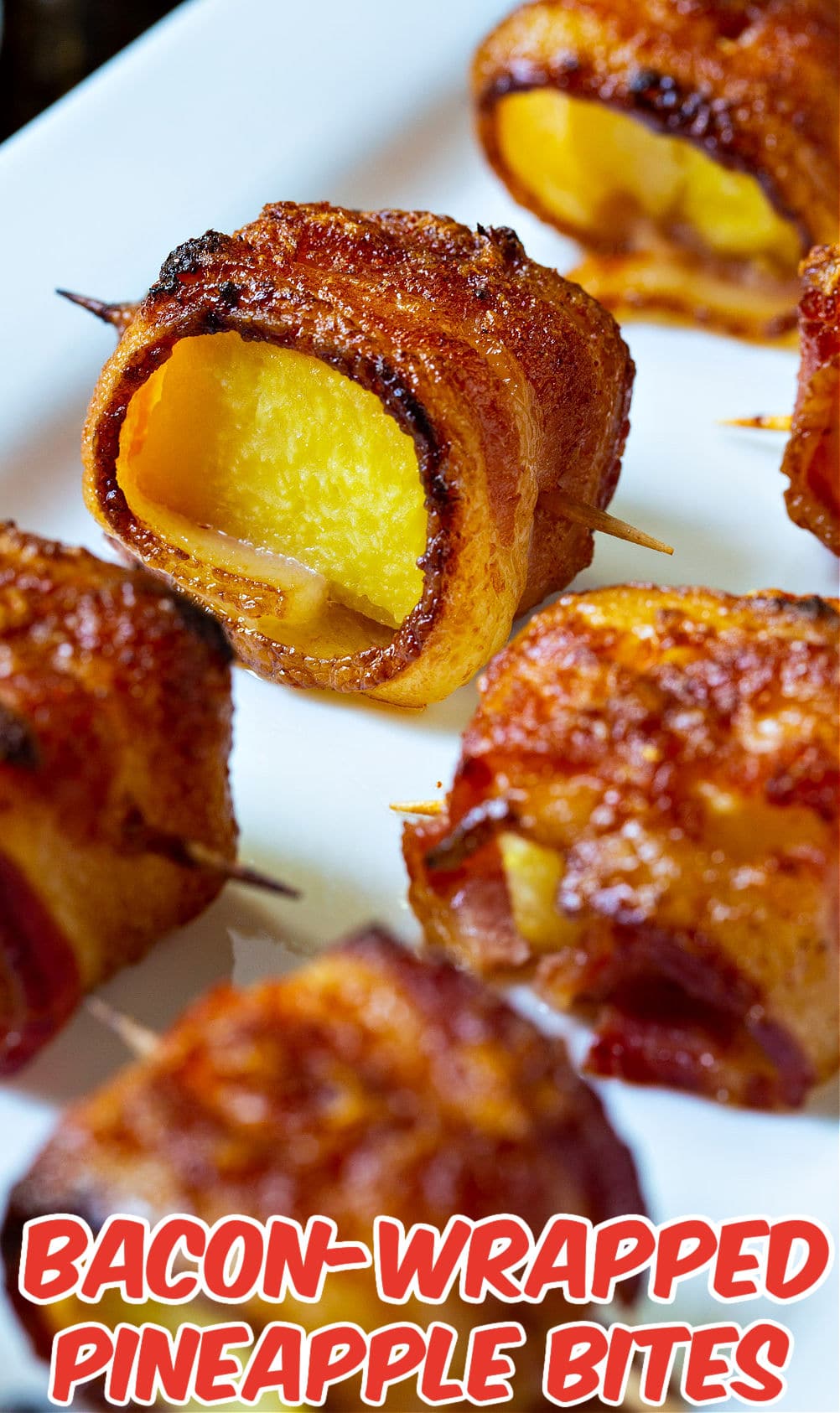 Spicy Bacon Wrapped Pineapple Bites on serving tray.