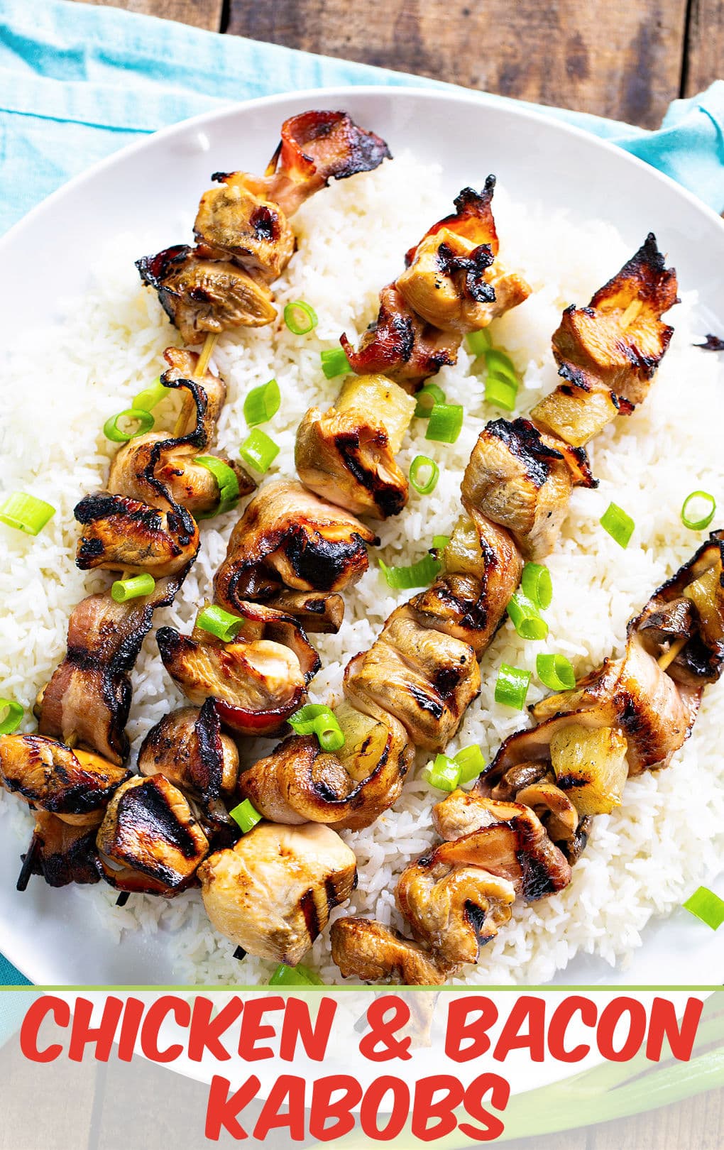 Chicken and Bacon Kabobs over white rice on a serving plate.
