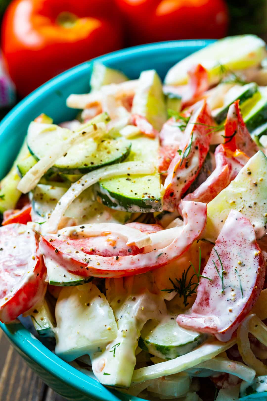 Creamy Tomato and Cucumber Salad in blue serving bowl.
