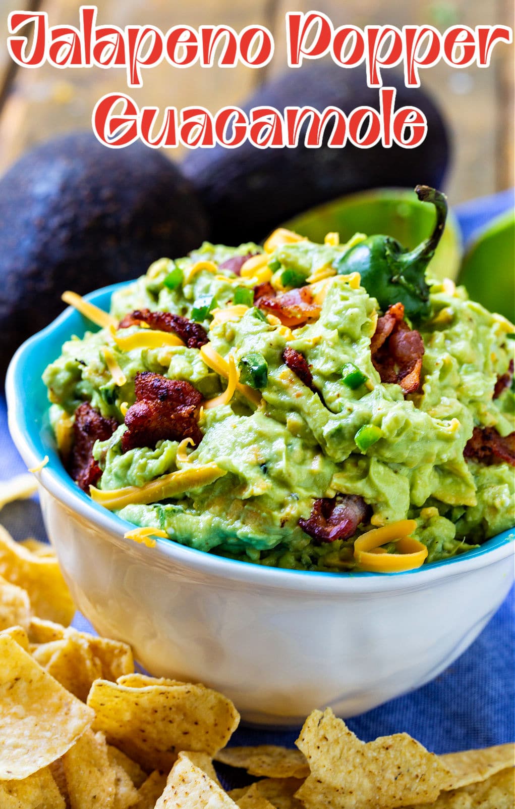 Jalapeno Popper Guacamole in a bowl surrounded by chips.