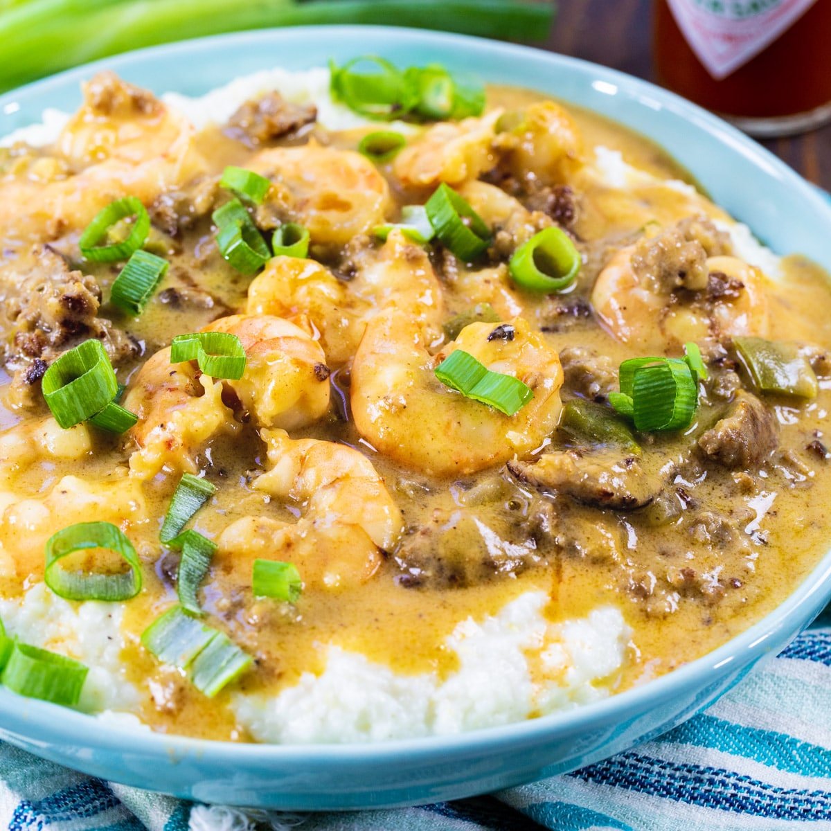 Sausage Gravy Shrimp and Grits in a blue bowl.