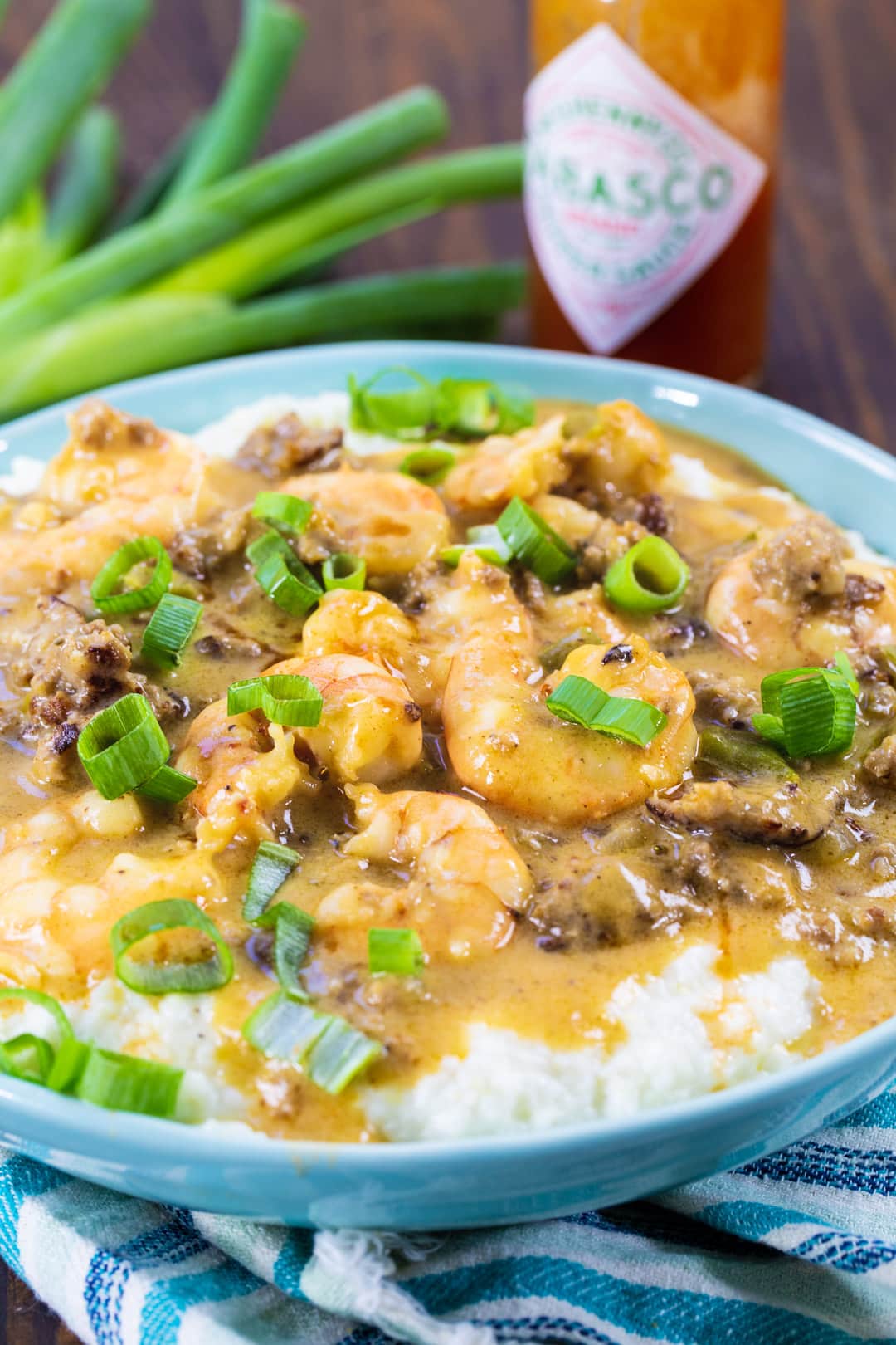 Sausage Gravy Shrimp and Grits in a blue bowl.