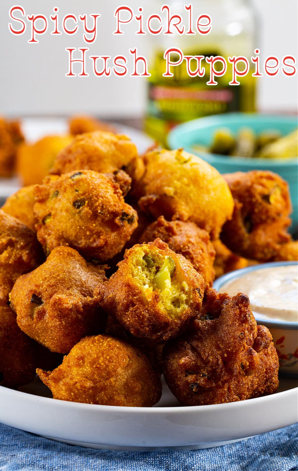 Plate of Spicy Pickle Hush Puppies with bite out of one hush puppy.