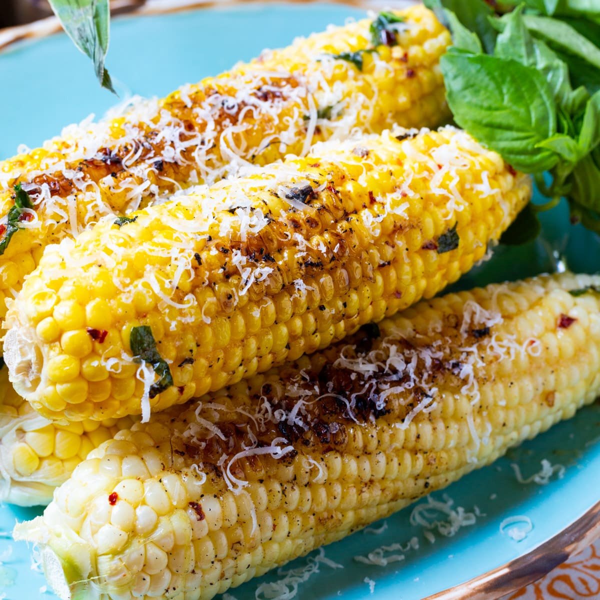 Grilled Garlic Parmesan Corn with fresh basil.