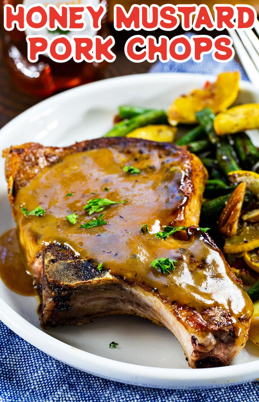 Honey Mustard Pork Chop on plate with green beans and squash/