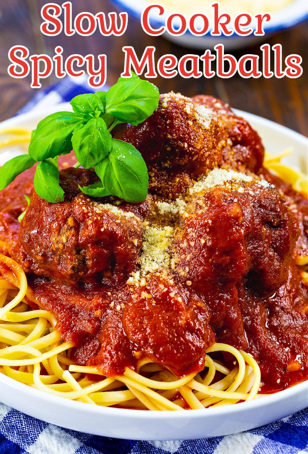 Slow Cooker Spicy Meatballs and Marinara served over spaghetti.