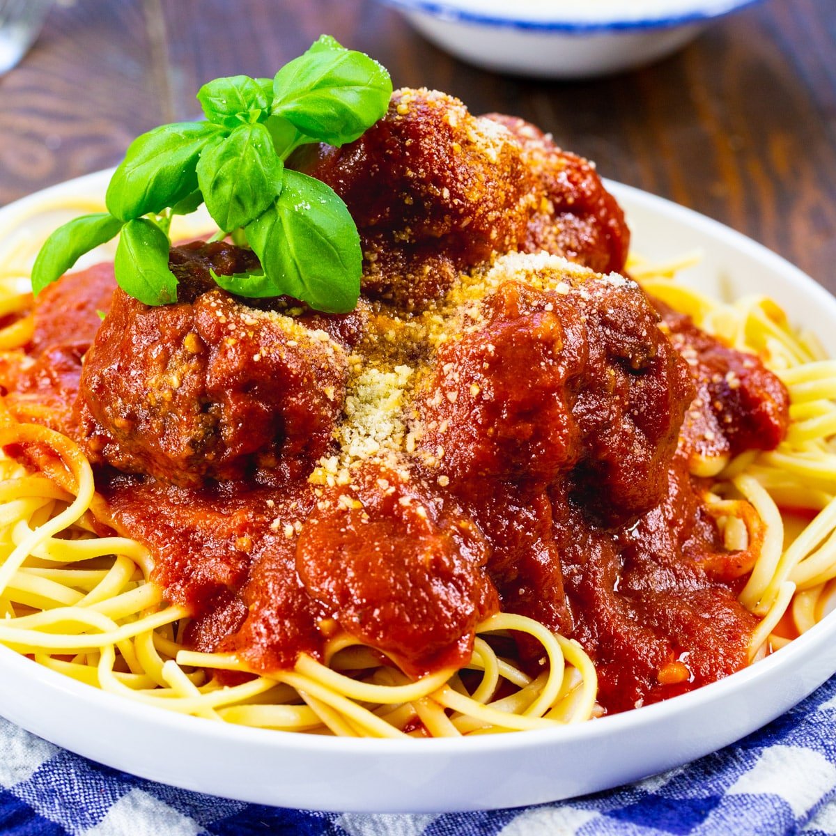 Slow Cooker Spicy Meatballs and Marinara served over spaghetti.