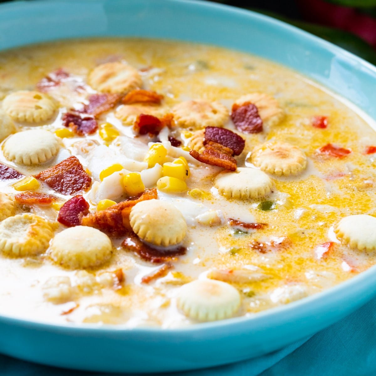 Crab and Corn Chowder topped with oyster crackers in a blue bowl.