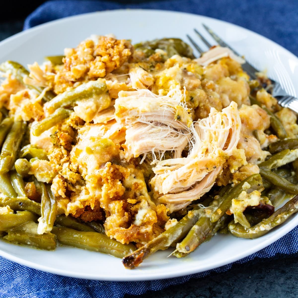 Crock Pot Chicken and Stuffing with Green Beans dished up on a plate.