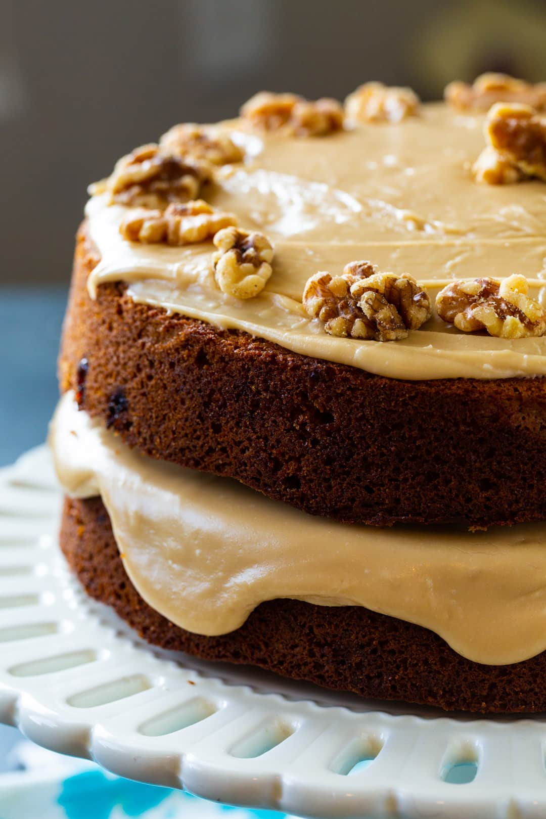 Kentucky Blackberry Jam Cake topped with walnuts on a cake stand.