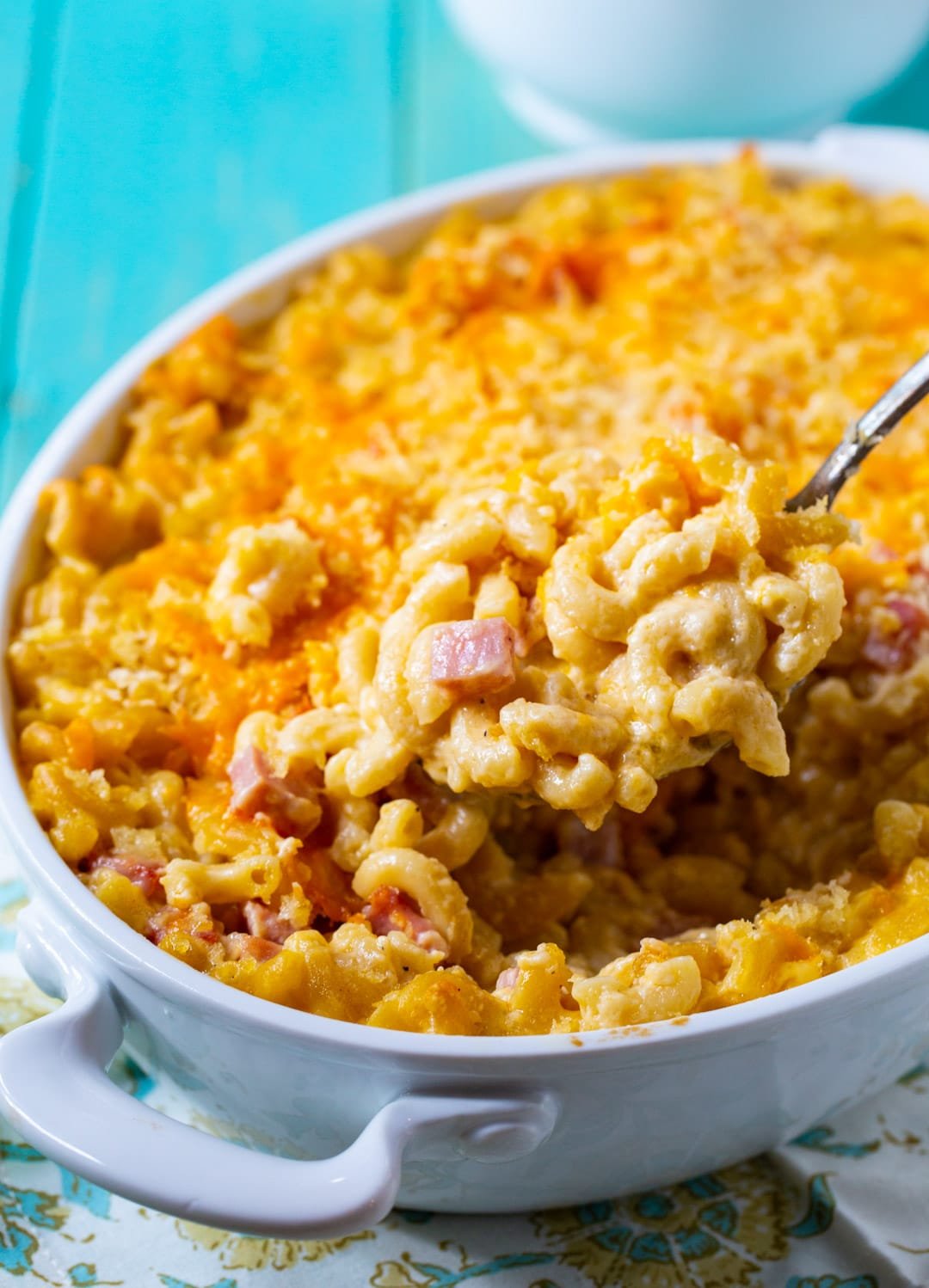 Spoon scooping up Mac and Cheese with Ham.