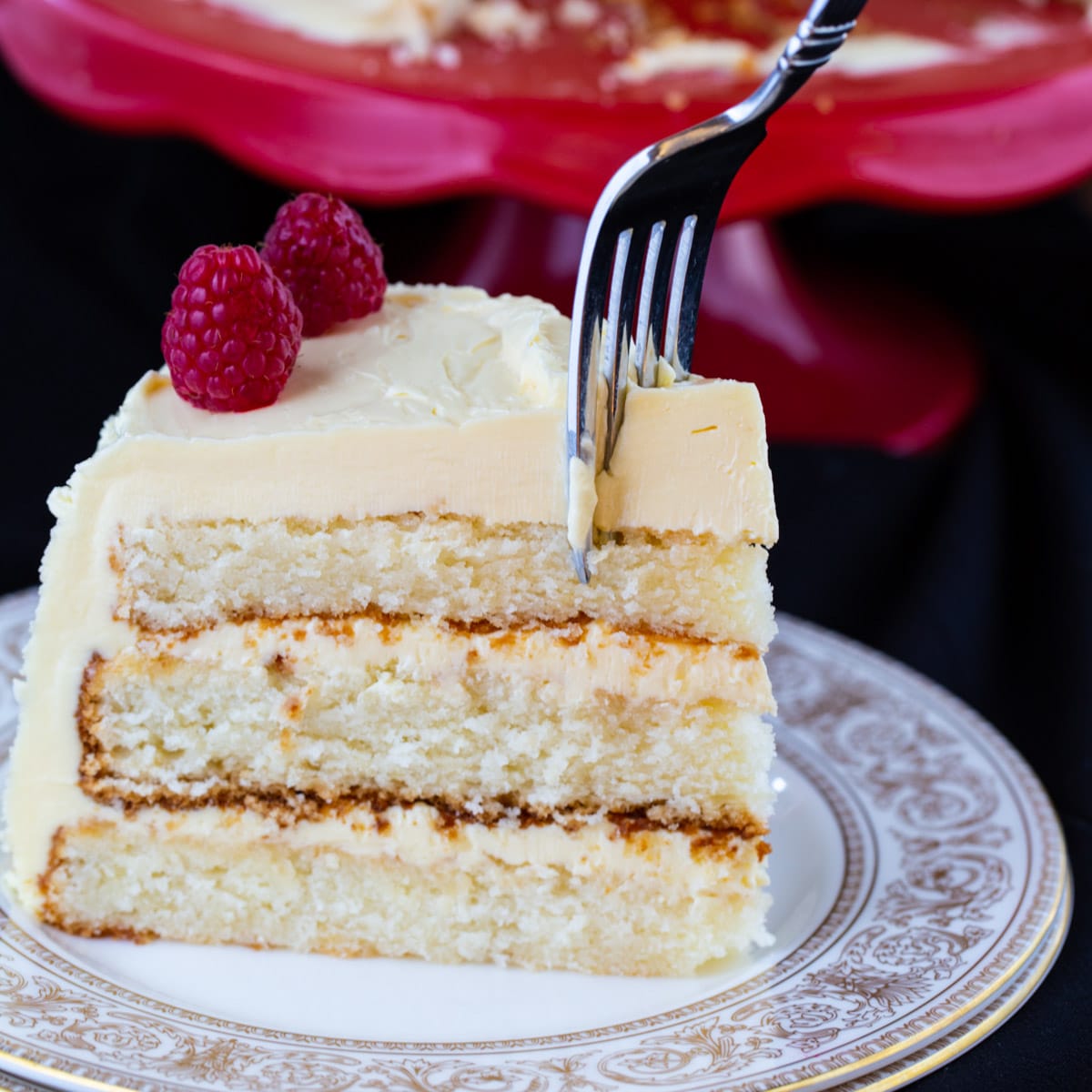 Slice of White Cake with Jack Daniels Buttercream on a plate.