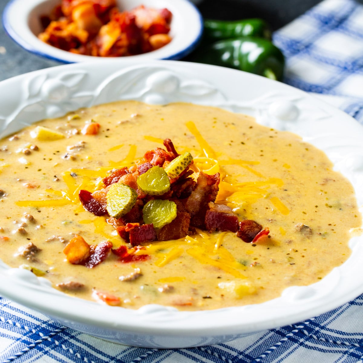 Jalapeno Bacon Cheeseburger Soup topped with crumbled bacon in a soup bowl.