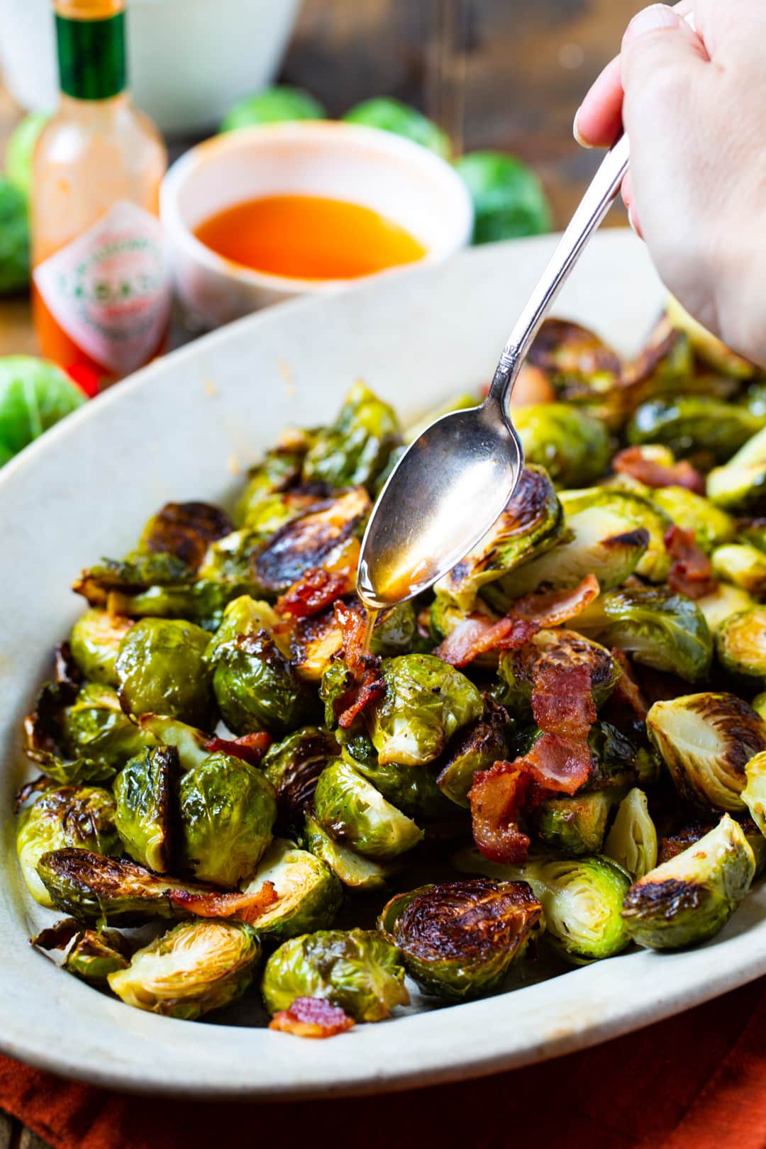 Brussels Sprouts getting drizzled with glaze.