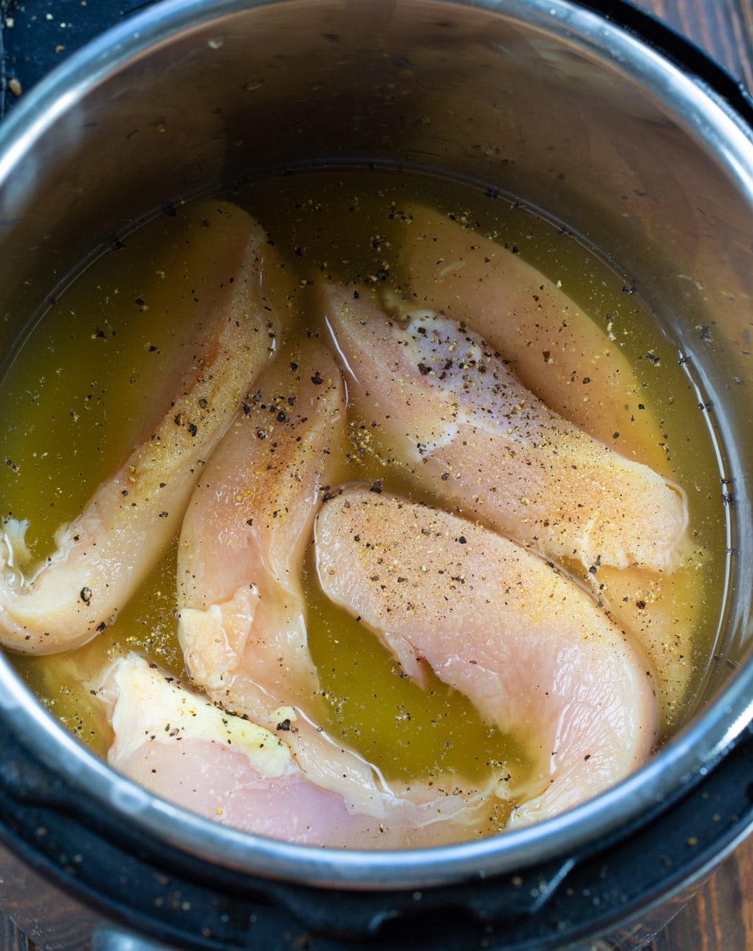 Chicken and chicken broth in the instant pot.