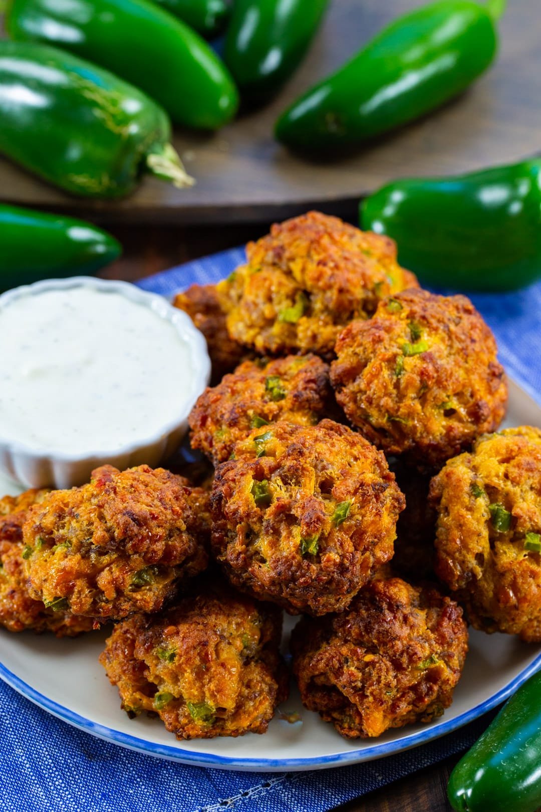 Sausage Balls on a plate surrounded by jalapenos.