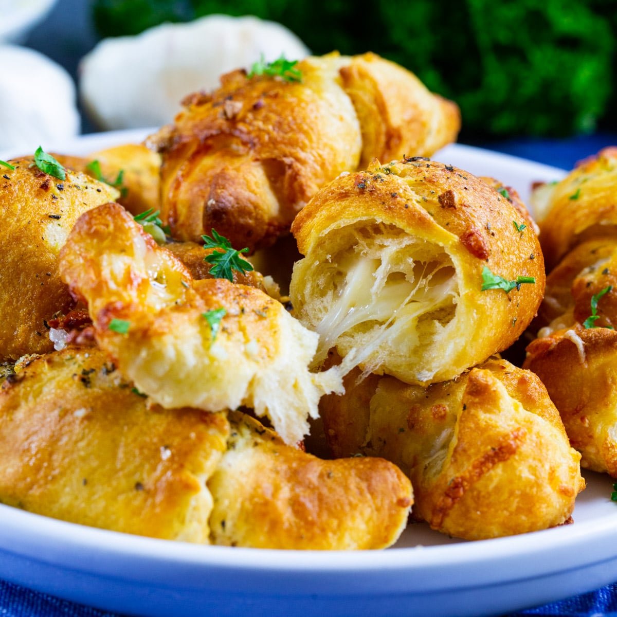 Air Fryer Cheesy Garlic Skillet Rolls with one roll cut open to show inside.