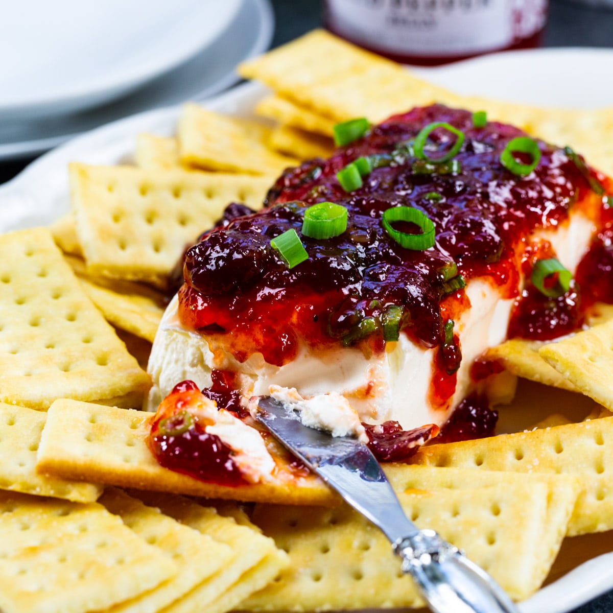 Cranberry Pepper Jelly Spread on a plate with Club crackers.