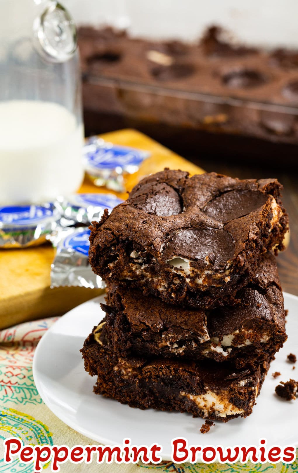 Peppermint Brownies stacked on a plate.