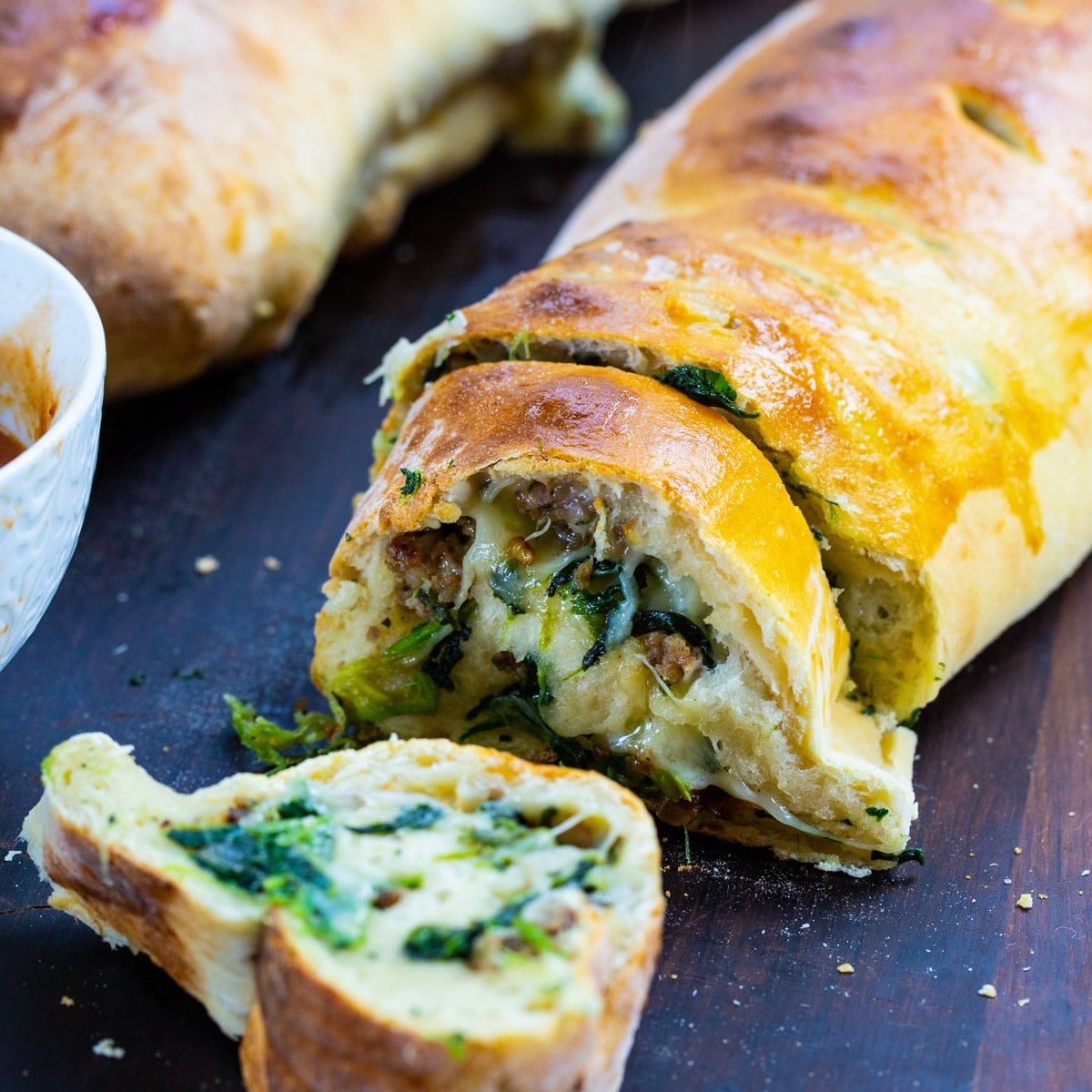 Sausage Spinach Bread with a couple of slices cut.
