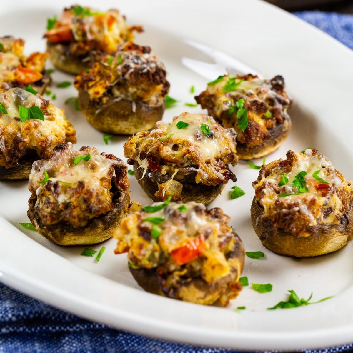 Air Fryer Sausage Stuffed Mushrooms connected  a plate.
