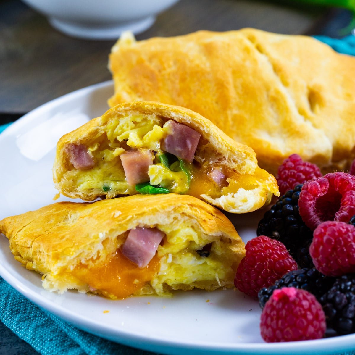 Air Fryer Ham and Egg Pockets on a plate with fresh fruit.
