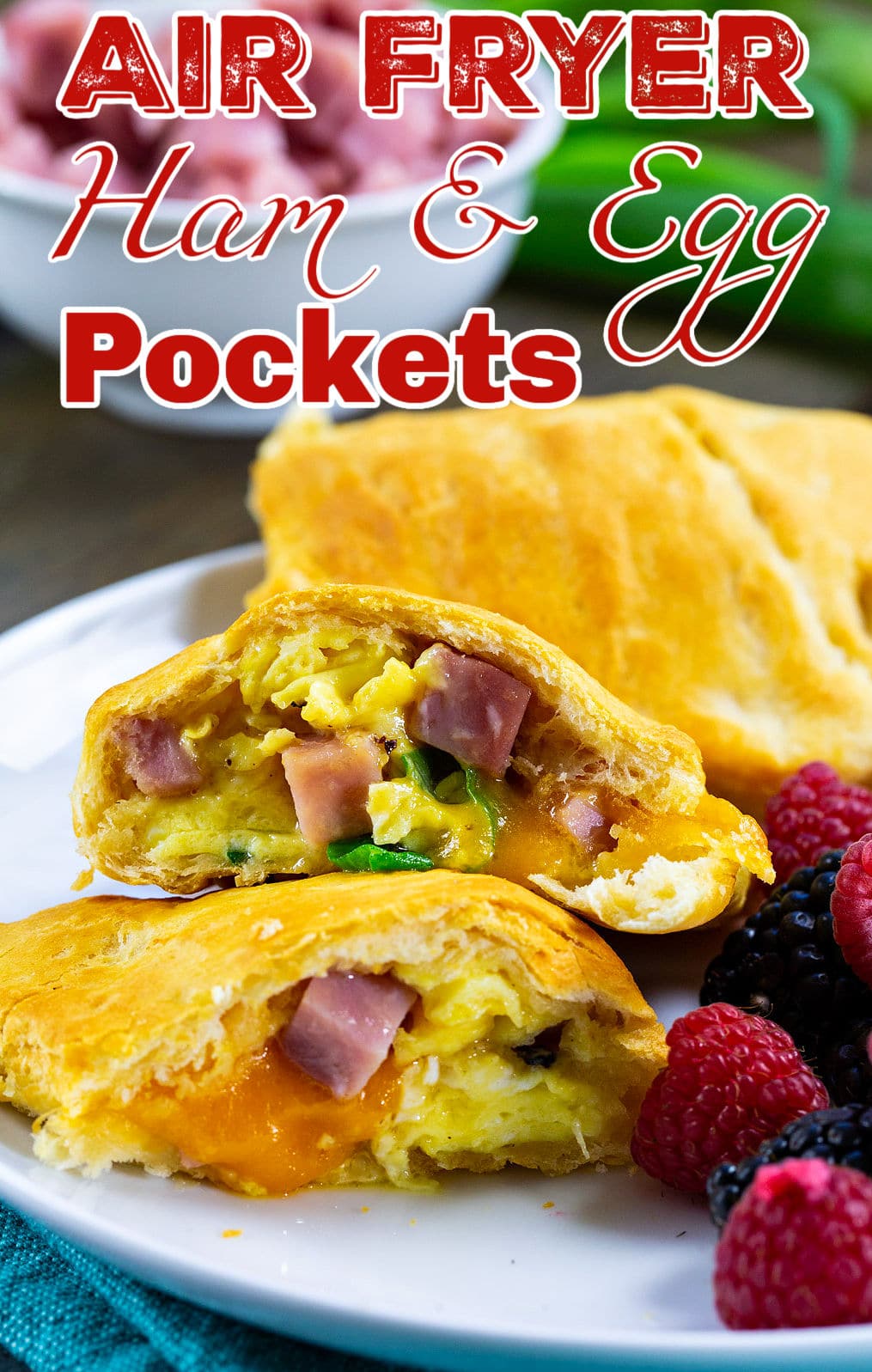 Air Fryer Ham and Egg Pockets on plate with fresh fruit.