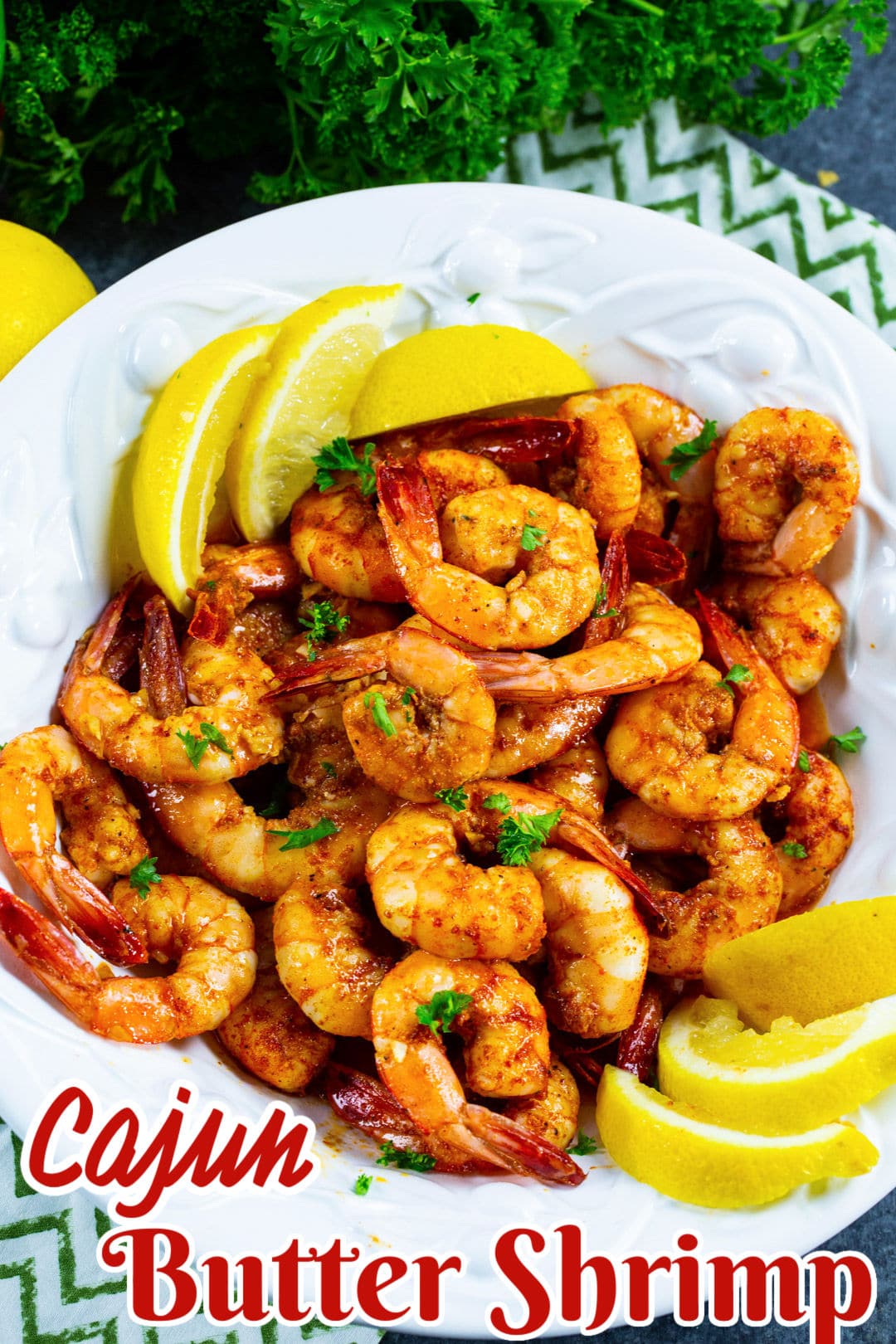 Cajun Butter Shrimp in a bowl with lemon slices.