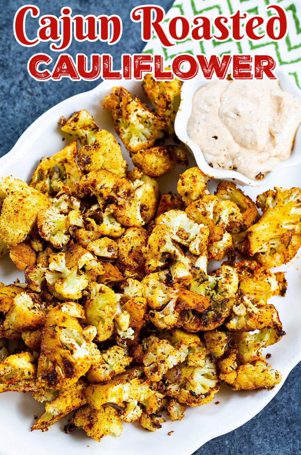 Cajun Roasted Cauliflower on a serving plate with remoulade sauce.