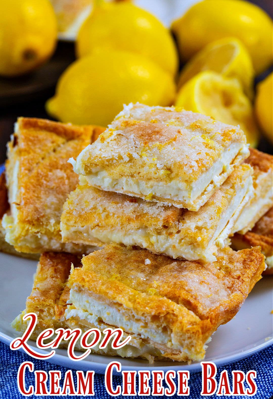 Lemon Cream Cheese Bars stacked on a plate.