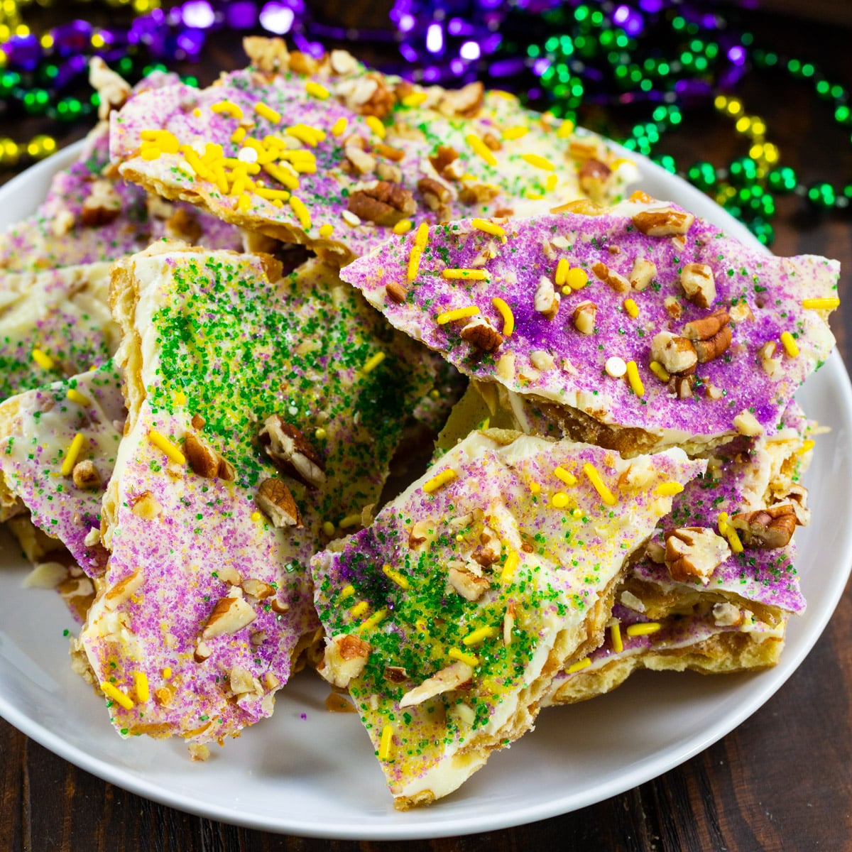 King Cake Cracker Candy connected  a plate.