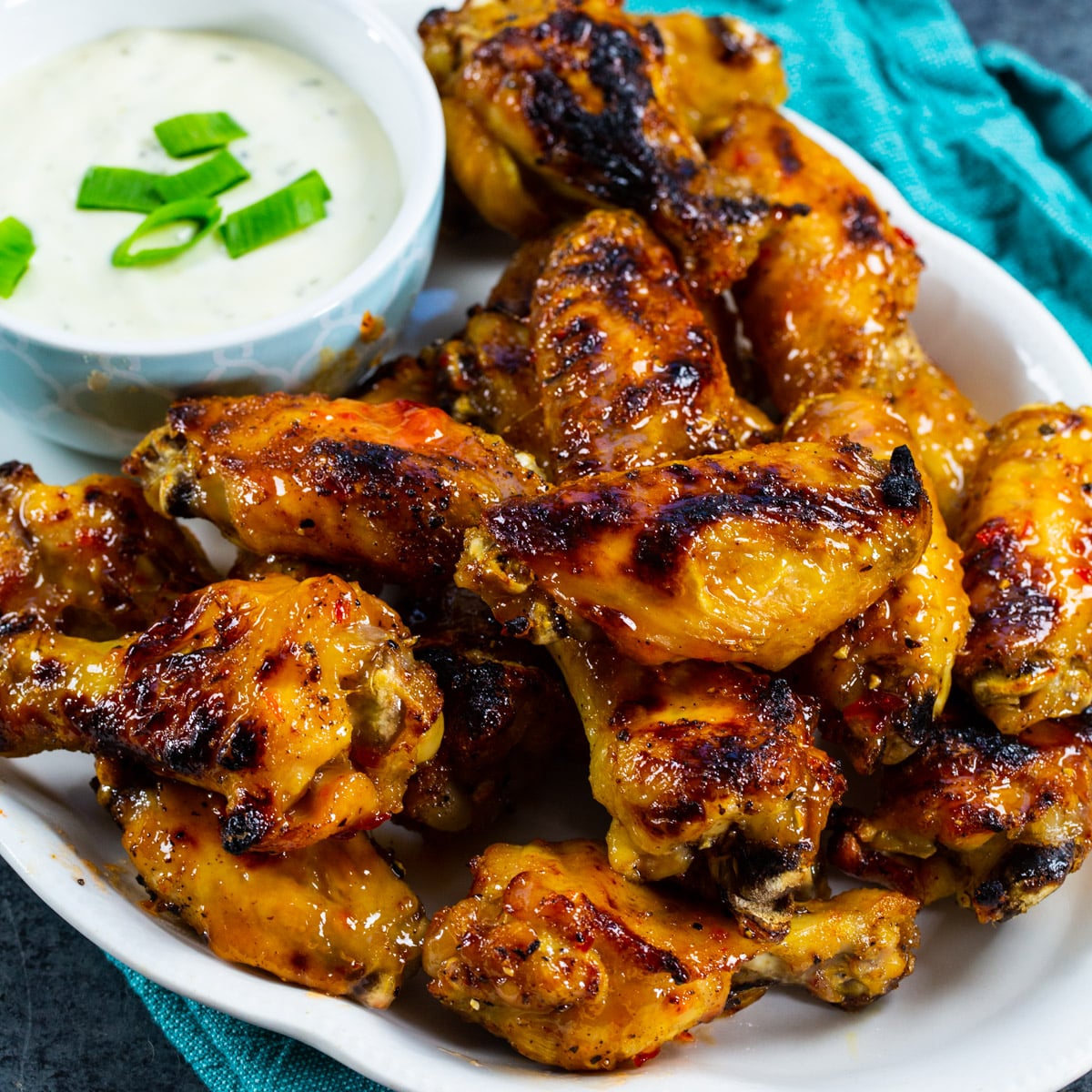 Pepper Jelly Wings on serving plate with bowl of ranch.