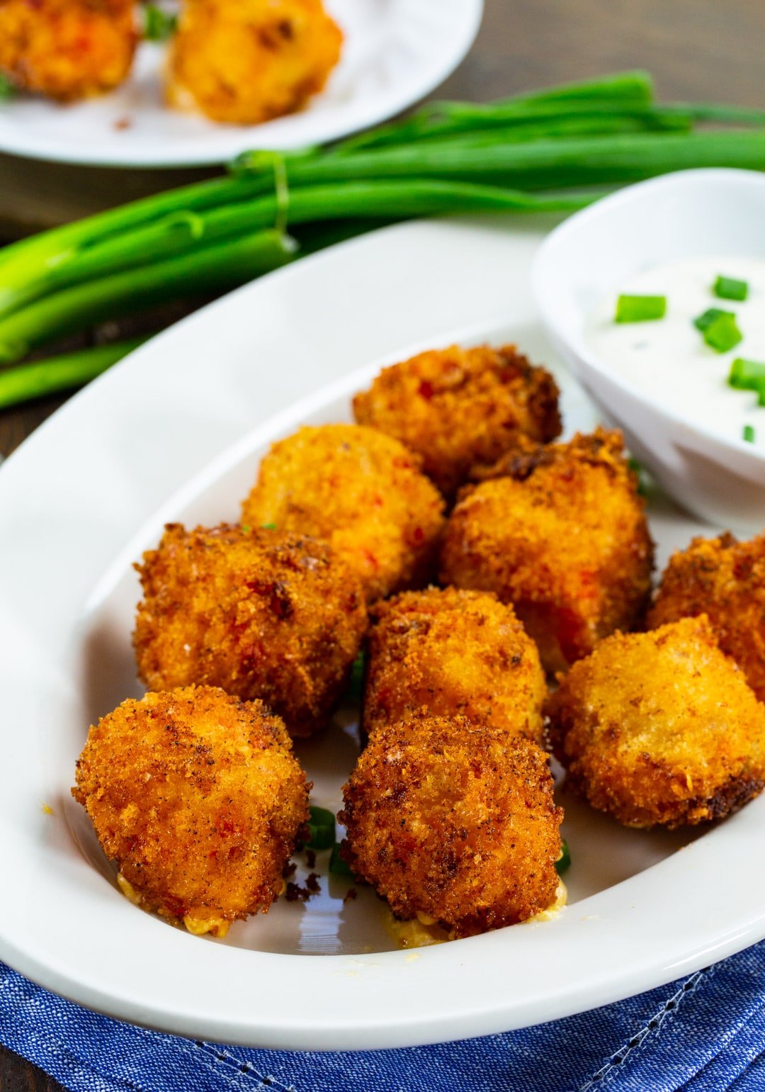 Cheese Balls on a plate with bowl of Ranch.