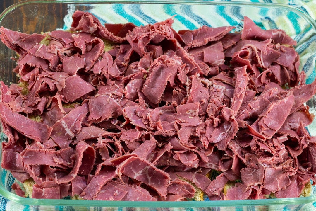 Corned beef pieces on top of bread cubes.