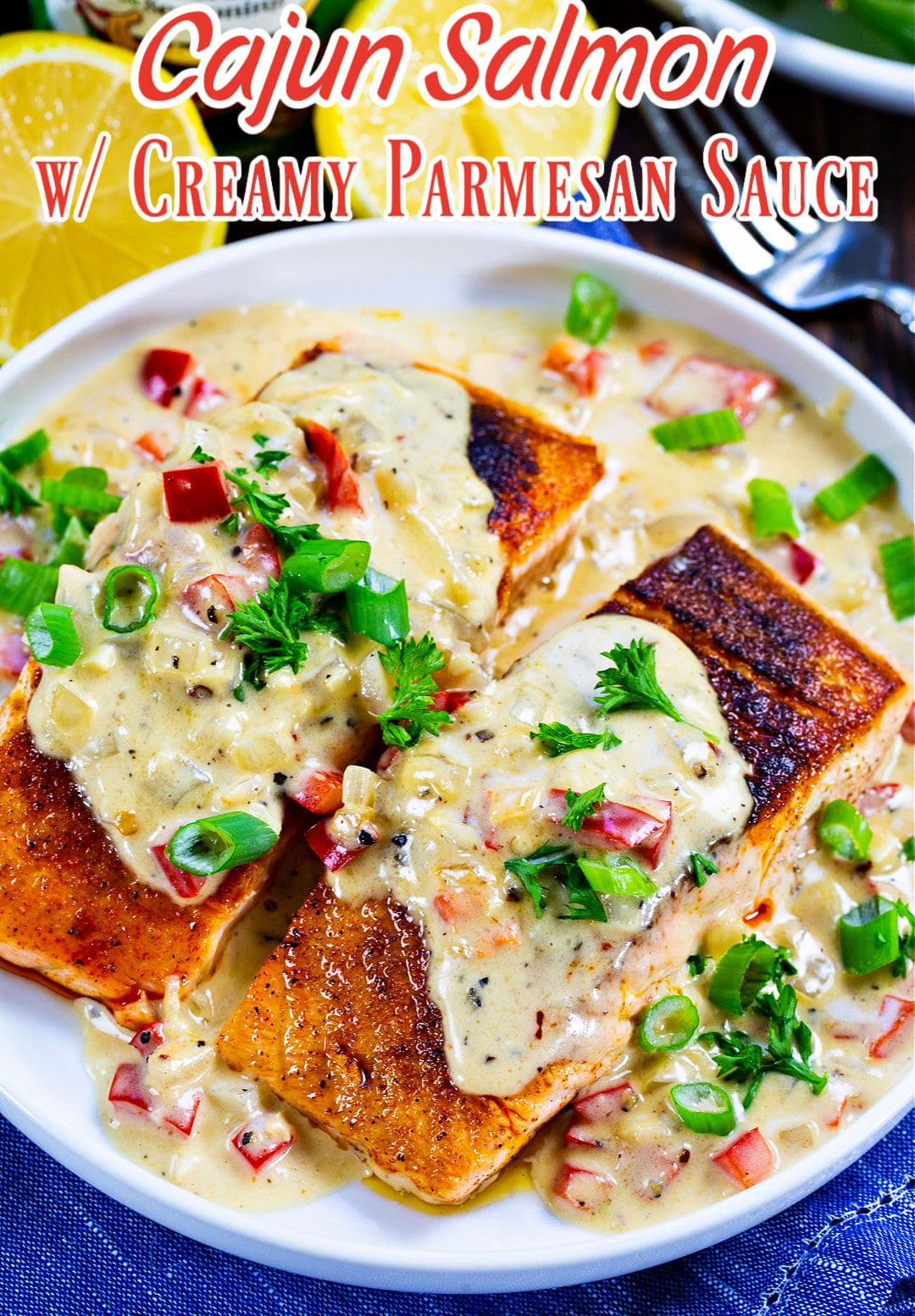 Cajun Salmon with Creamy Parmesan Sauce dished up on a plate.