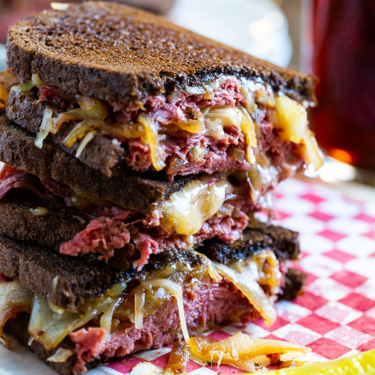 Corned Beef Grilled Cheese halves stacked on top of each other.