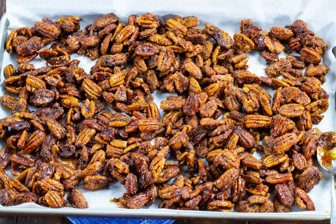 Pecans spread out on a baking sheet.